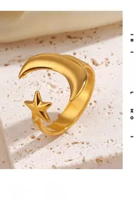 Detail of adjustable gold ring featuring crescent moon and star motifs on stone