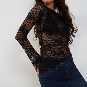 Detail eines eleganten schwarzen Spitzen-Langarmshirts mit ausgestellten Manschetten