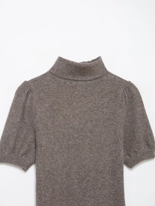 Detailed view of the brown knit mini dress featuring ribbed high neck and puff short sleeves