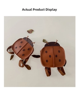Detailed view of ladybug-shaped kids backpack with cute 3D antennae and brown dots