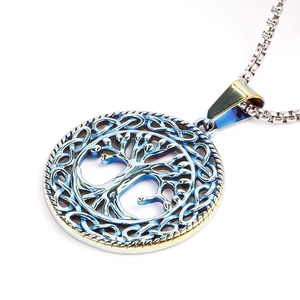 Macro view of a round Tree of Life pendant with blue and yellow gradient finish