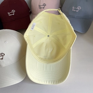 Cotton baseball caps with cute dog embroidery in multiple colors like beige and yellow