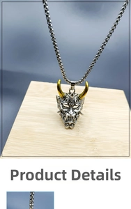Detail view of retro silver Hannya mask pendant with golden horns on stainless steel chain