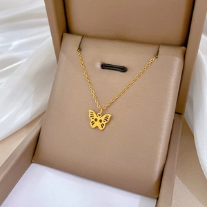 Elegant gold hollow butterfly pendant necklace in titanium steel on beige jewelry box