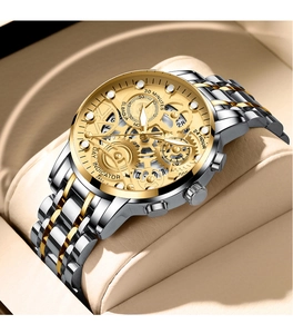 Macro detail of men's stainless steel watch with golden skeleton dial and gears
