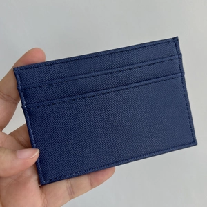 Detailed macro view of navy blue Saffiano leather card holder with smooth stitching