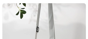 Close-up of light gray adjustable fabric shoulder strap with black plastic buckle detail