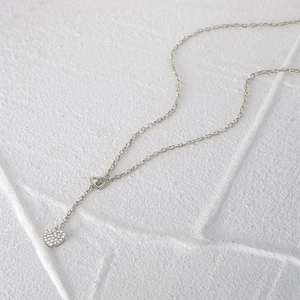 Macro detail of silver S925 heart pendant necklace with shimmering zircon pavé stones