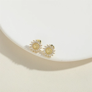 Virgin Mary gold earrings with marquise cut zircon stones in a sunburst design