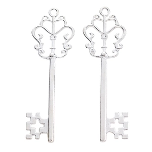 Macro detail of silver vintage hollow crown key charms for DIY jewelry making