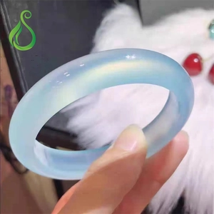 Close-up of a translucent light blue agate chalcedony bangle with a polished finish
