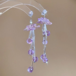 Detail of purple chiffon flower earrings with clear beads and sparkling rhinestone studs