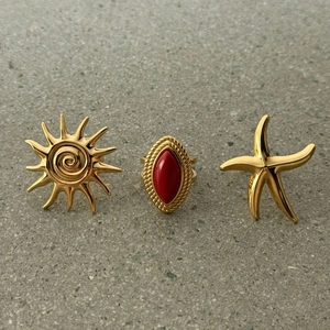 Gold stainless steel rings featuring red agate, sun pattern and starfish designs