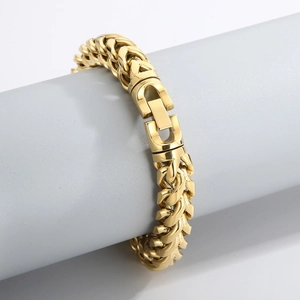 Close-up of a gold dragon link bracelet with lobster clasp on a display stand