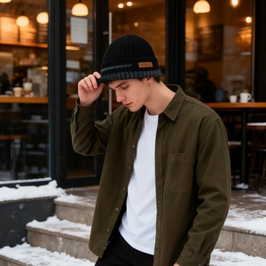 Outdoor winter scene of men's black knit beanie with fleece lining and warm ear protection