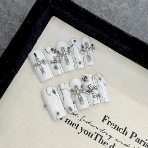 White marble press-on nails with silver crosses and pearls in long trapezoid shape