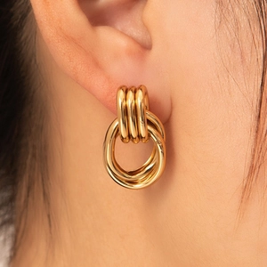 Minimalist gold-tone triple interlocking hoop earrings in a modern geometric design