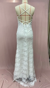 Detail of white lace embroidery and cross-back straps on this elegant fishtail dress