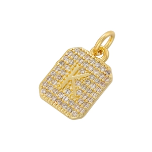 Macro shot of gold-plated square pendant with pavé cubic zirconia and letter K detail