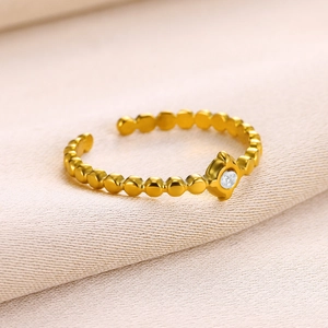 Close-up of 18k gold-plated stainless steel ring with a round zircon and beaded band