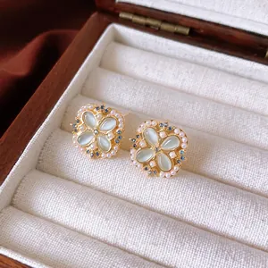 Elegant gold flower jewelry set with blue opal petals, pearls and zircon accents