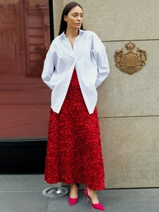 Detail of red 3D floral textured maxi skirt with layers and ruffled A-line hem
