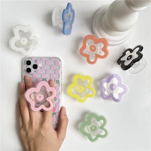 Transparent floral cell phone grip sockets in various colors shown on white background