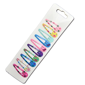 Vue détaillée de dix barrettes colorées avec motifs sur support blanc pour enfants