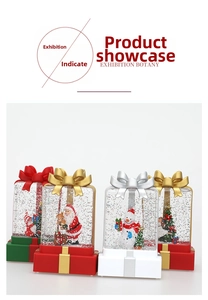 Detail of Christmas lantern gift boxes featuring Santa and snowman with sparkling glitter