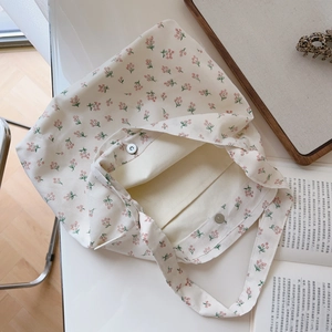 Off-white floral cotton tote bag with interior pocket and magnetic buckle closure