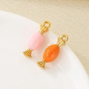 Close-up of pink and orange enamel candy pendants with 18K gold plated metal loops