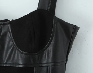 Detail of black faux leather and suede patchwork stitching on a sexy camisole dress