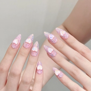 Pink aurora stiletto press-on nails with 3D heart charms and laser glitter finish