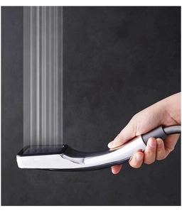 Detail showing pressurized 300-hole water flow from square silver handheld shower head
