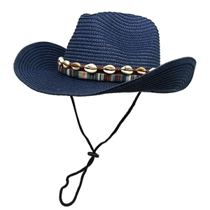 Detail of navy straw fedora hat featuring sea shell band and adjustable chin strap