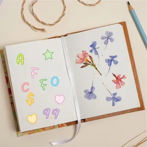 Detail of creative scrapbook with colorful alphabet stickers and dried flower specimens