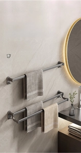 Modern gun grey double-tier towel rack in matte aluminum mounted on grey stone wall