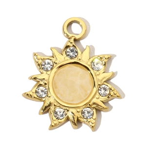 Detailed macro of a gold sun pendant with a yellow center stone and white rhinestones