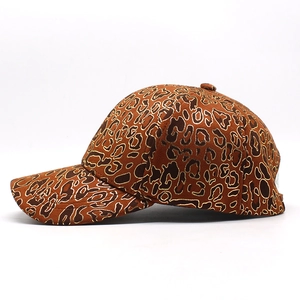 Detail of leopard print baseball cap featuring gold thread embroidery and structured seams