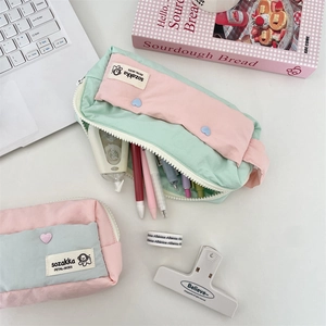 Detail of high-capacity canvas pencil case showing multi-compartment storage