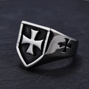 Macro view of vintage stainless steel shield ring with Maltese Cross and side cutout