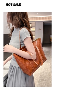 Caramel brown oil wax leather tote bag shown on model highlighting spacious daily capacity