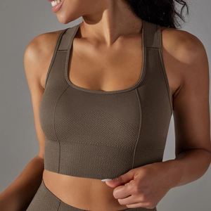 Close-up of seamless knitted sports bra showing honeycomb breathable texture and wide rib band