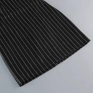 Detailed close-up of vertical rhinestone stripes on black bodycon party dress fabric