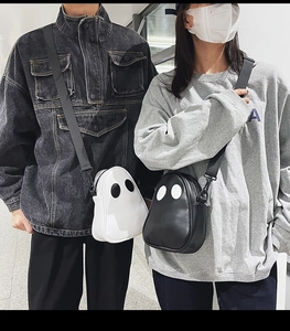 Detail of cute ghost-shaped PU leather crossbody bags in black and white colors