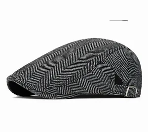 Close-up of herringbone flat cap fabric texture with side silver adjustable buckle