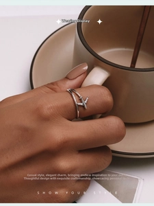 Detail showing cross-band airplane ring in S925 silver with sparkling zircon wings
