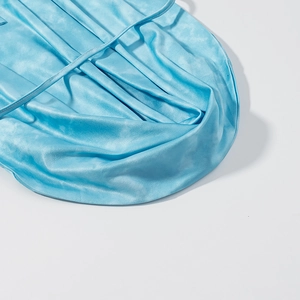Close-up of light blue satin fabric with silky texture and elegant glossy finish