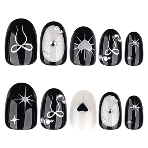 Gothic black and white Y2K press-on nails with 3D bows, hearts and pearl decorations
