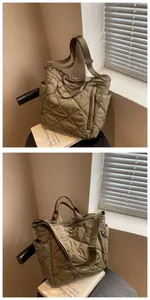 Detail view of khaki quilted tote bag featuring padded nylon texture and side pocket